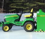 View of Model 100 behind John Deere tractor.